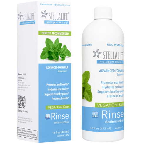A bottle and box of StellaLife Vega Oral Care Rinse in spearmint flavor. The packaging is white with blue and green accents, and features mint leaves and product information promoting oral health.