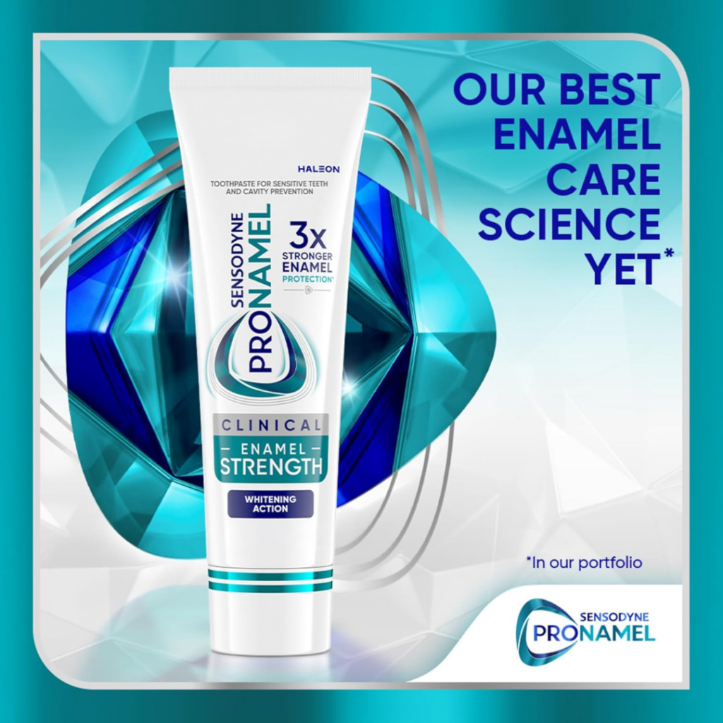 A tube of Sensodyne Pronamel Clinical toothpaste stands upright against a blue geometric background, showcasing one of our top products with text reading Our best enamel care science yet and 3x stronger enamel protection.