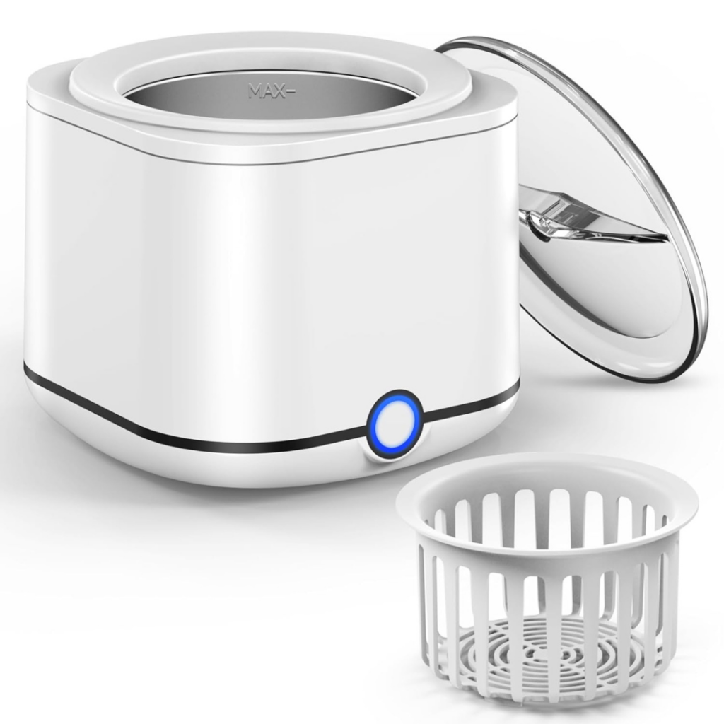 A white ultrasonic jewelry cleaner, ideal for caring for your products, features a blue power button, an open stainless steel lid, and a removable basket placed in front of the device.